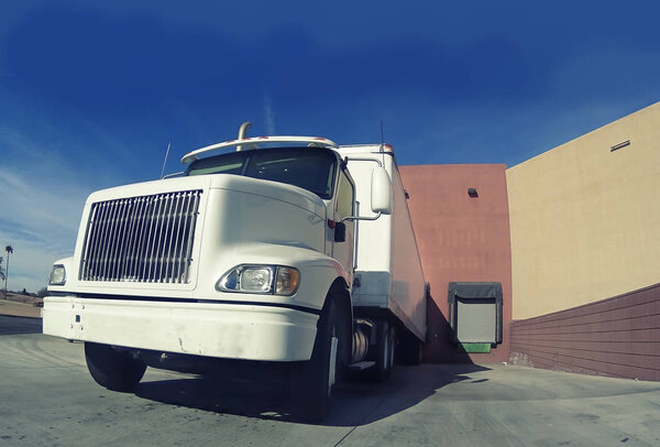 Heavy goods truck at warehouse loading doc