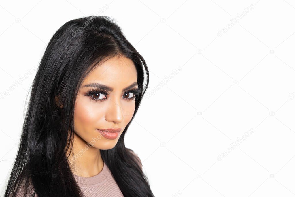 Studio shot of beautiful woman with long black hair isolated against white background