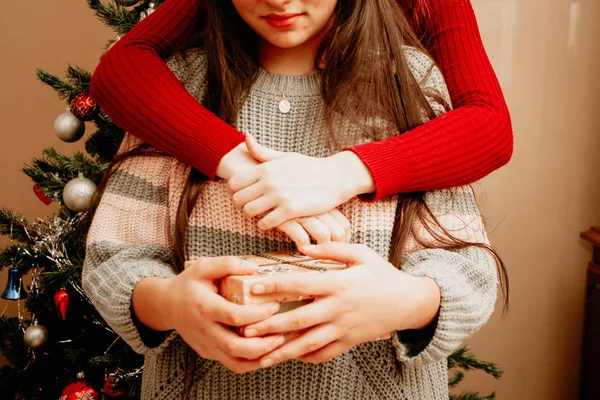 Girl with a gift near to Christmas tree — Stok fotoğraf