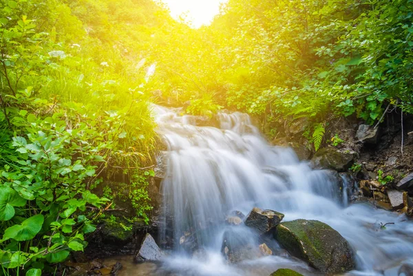 Beautiful blue waterfall on a mountain river — Stock Photo, Image