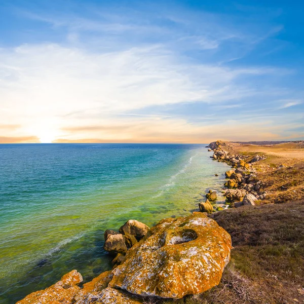 Sunset over a sea bay — Stock Photo, Image
