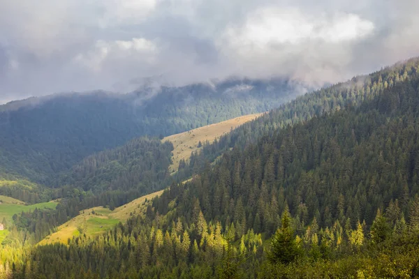 Green mountains under a dark dense clouds — Stock Photo, Image