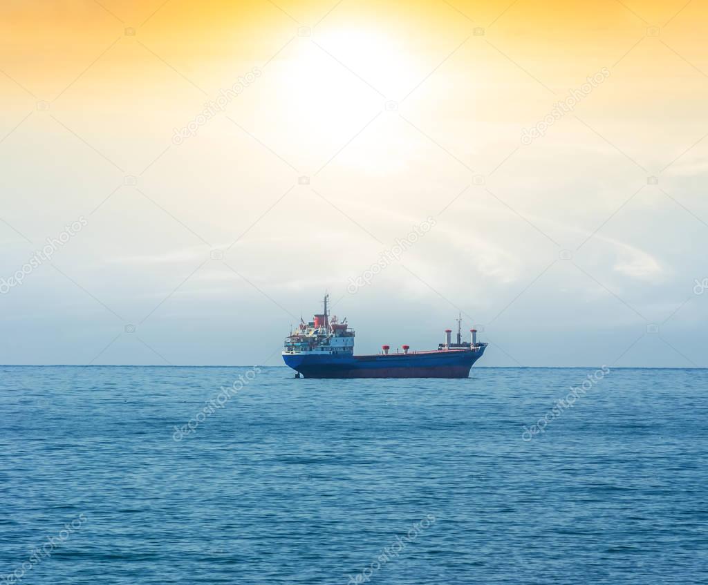 cabotage ship in a sea at the sunset