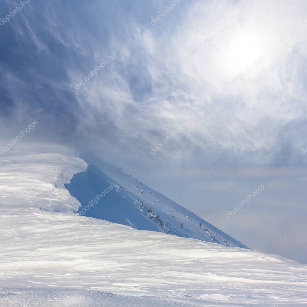 snowbound mountain ridge in a mist