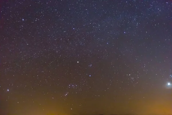 orion constellation on a night sky background