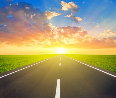 asfalt yol kadar avay gün batımında bırakarak bir yeşil alanlar arasında