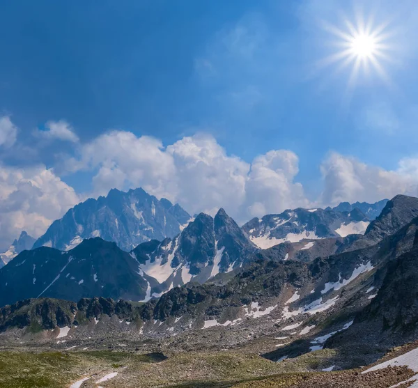 mountain ridge in a snow under a sparkle sun