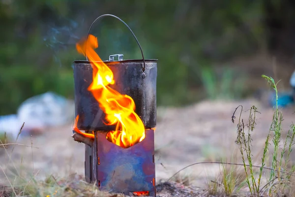 touristic wooden stove with cauldron on a fire