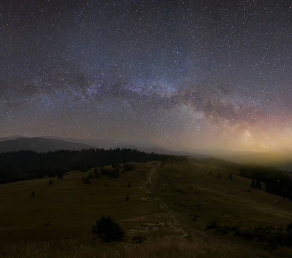 night mountains under a  stary sky with milky way in a glow