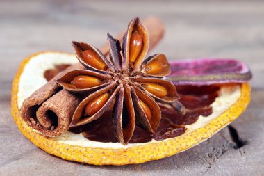 traditional spices. star anise, cinnamon and dry citruses on a wooden table close up