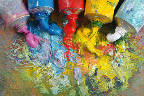 tubes with art oil paint on a palette. colorful art paints top view