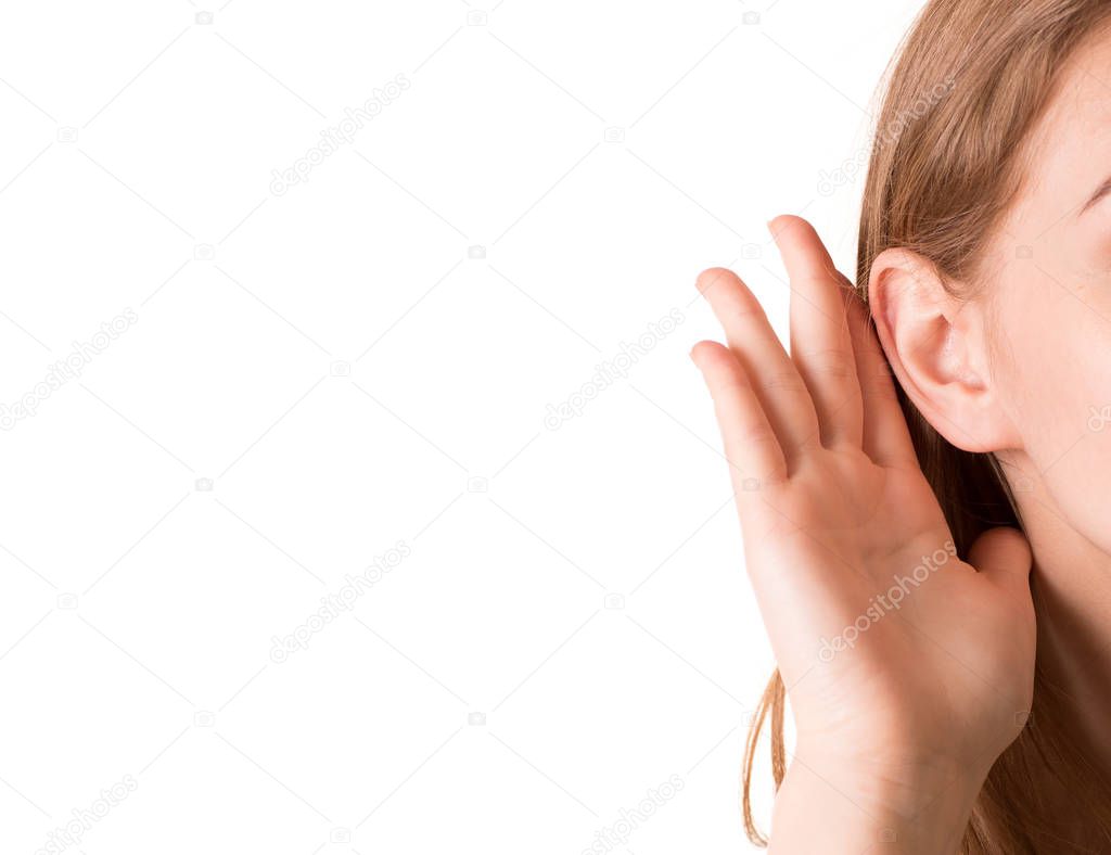 Girl holds ear to listen better sound isolated white background