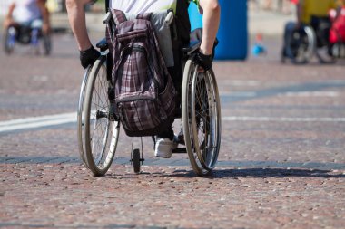 Disabled man rides a wheelchair clipart