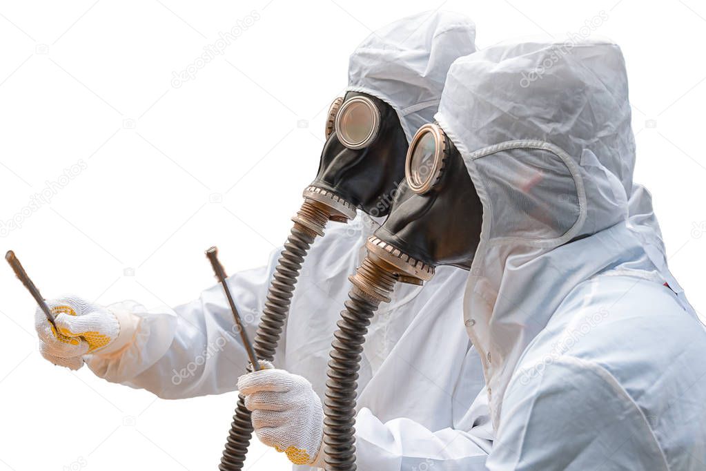 Two men in bio-hazard suits and gas masks. Two men in bio-hazard suits, both wear gas masks with flexible rubber breathing tubes. One of them holds a pair of rusty steel bar.