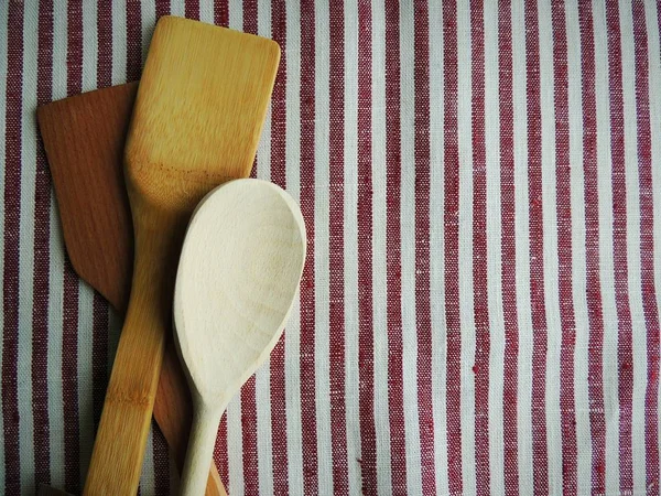 Wooden handmade spoon. Food photo props. Natural striped red white linen cotton fabric, tablecloth.