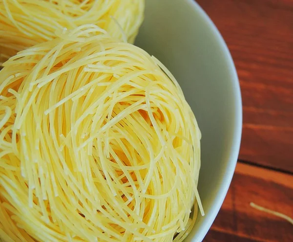 Raw pasta, macaroni nests. Pasta italian food cooking.