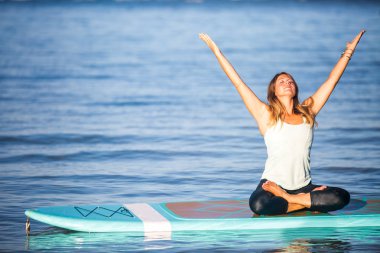 Sunrise SUP Yoga practice  in Waikiki meditation clipart