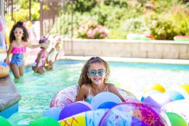 Summer pool fun cute girls in inflatable rings clipart