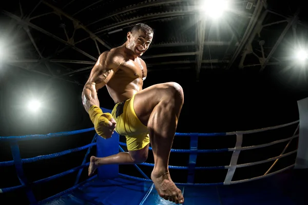 Boxeador tailandés en el ring de boxeo, salto y patadas —  Fotos de Stock