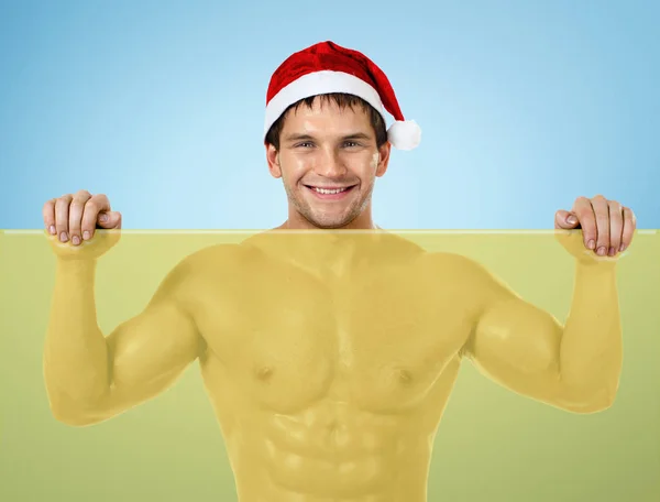 Fitness sexy Santa Claus , stand with yellow banner and smile — Stock Photo, Image