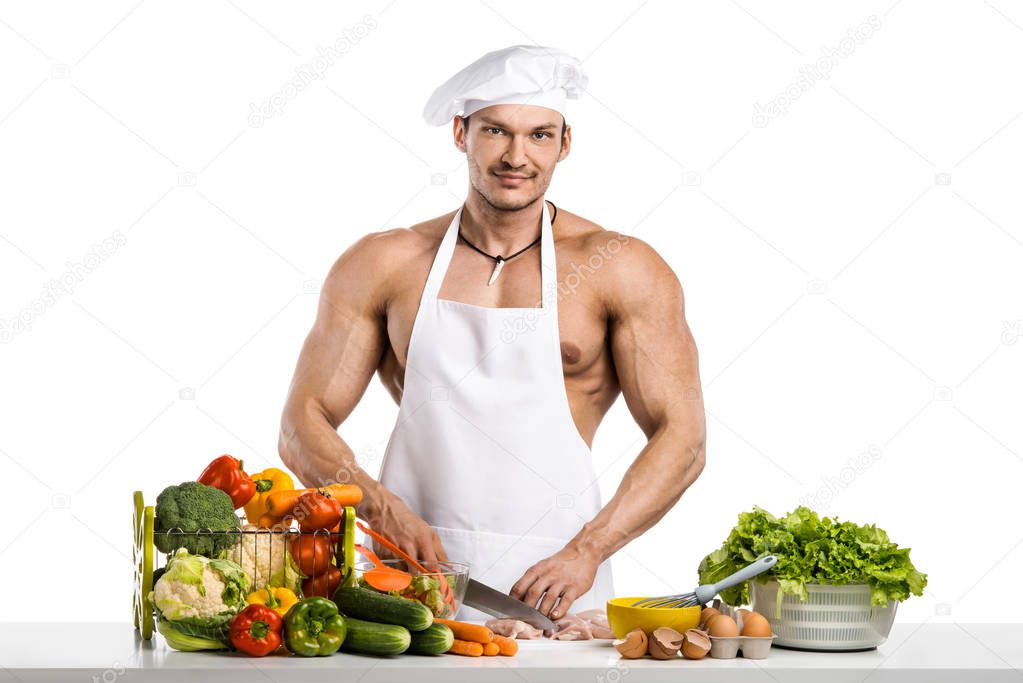 Man bodybuilder in white toque blanche and cook protective apron