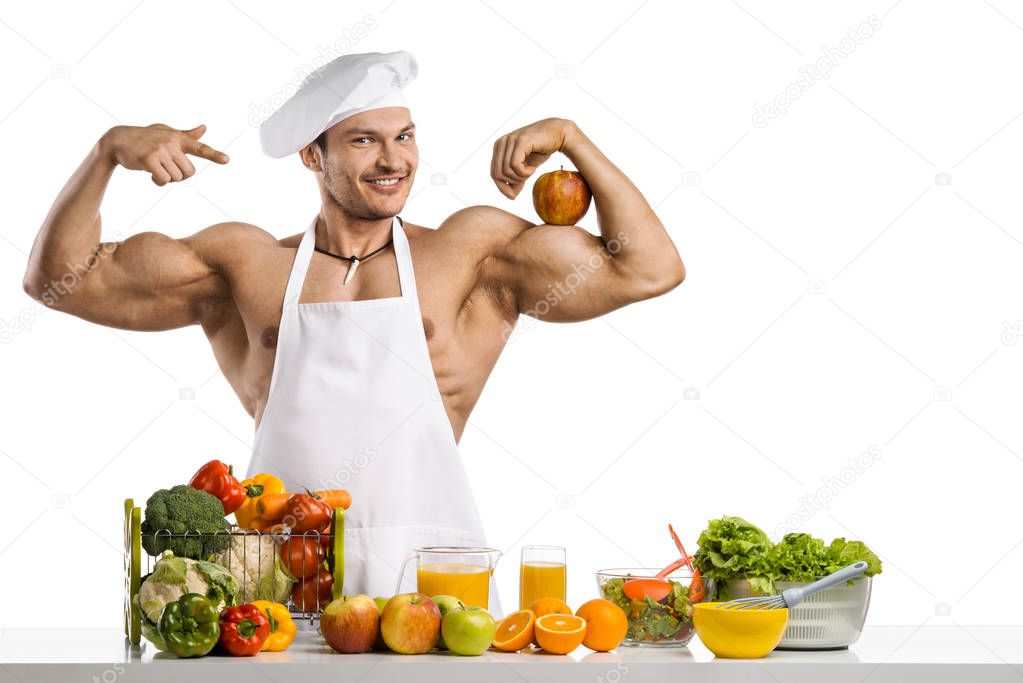 Man bodybuilder cook with apple on biceps