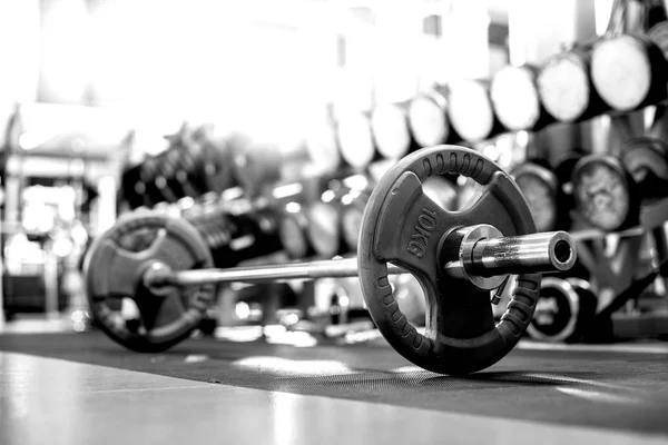 sports equipment , weight in light gym room, close up horizontal black-and-white photo