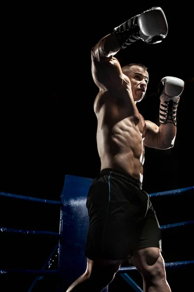 Punching boxer on boxing ring — Stock Photo, Image