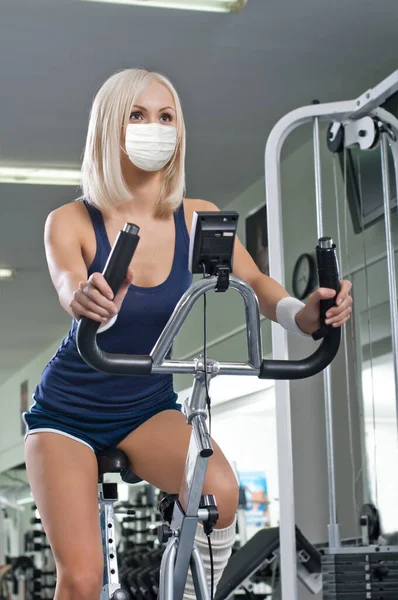 戴着医疗面罩在健身房健身的女孩 概念Covid 19珊瑚流感大流行 — 图库照片