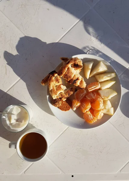 European vacation healthy breakfast food. Whole grain bread, orange tangerines at resort villa balcony. Table for two on outdoor hotel balcony caldera view on Alanya, Turkey