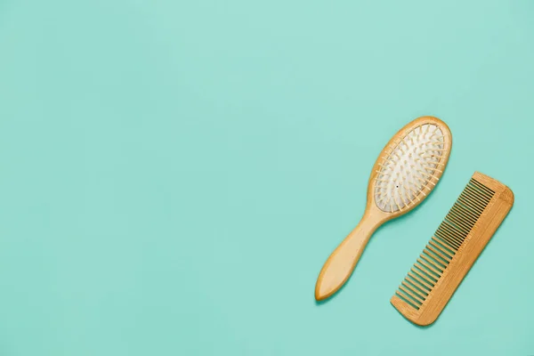Two hair combs on a mint background. View from above