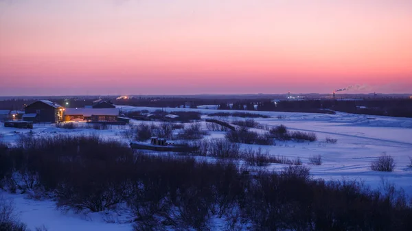 Magnificent winter sunrise in Narian-Mar with snow covered river fir forest and tundra. Great outdoor scene, natural magenta, pink and blue colors