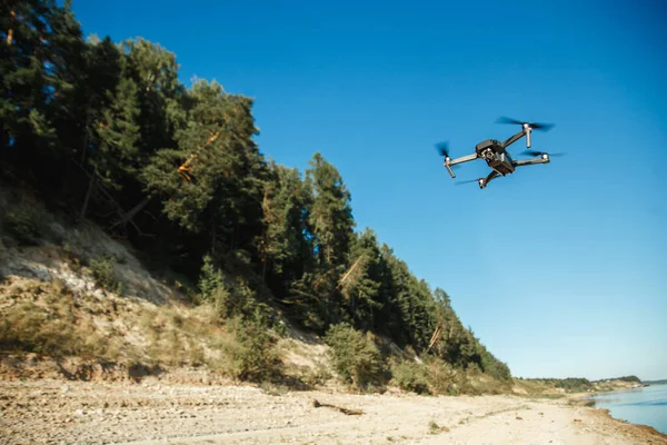 Compact Drone flying over the forest landscape — Stockfoto