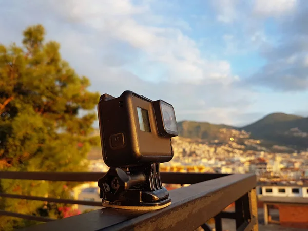 Taking timelapse on action camera on sunrise mountain landscape