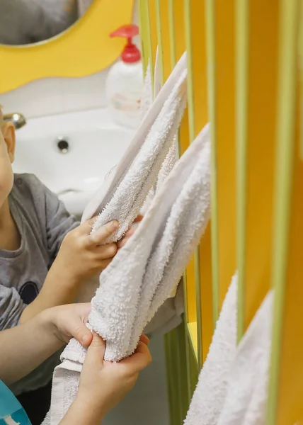 Toddlers wipe clean hands with a towel. Concept hygiene
