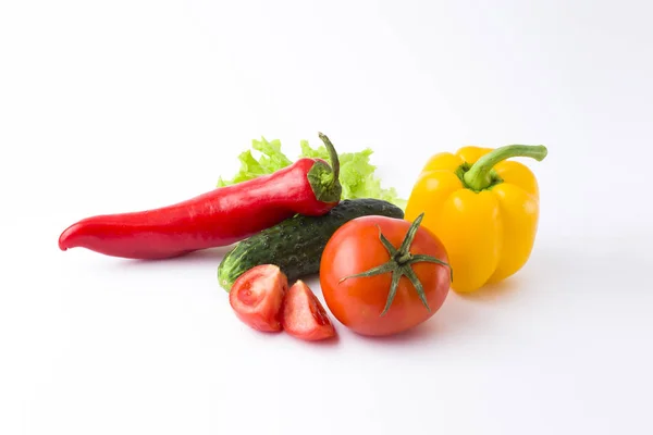 Red peppers and yellow peppers with tomatoes on a white backgrou — Stock Photo, Image