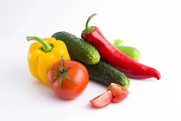 Red peppers and yellow peppers with tomatoes on a white backgrou — Stock Photo, Image
