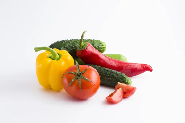 Red peppers and yellow peppers with tomatoes on a white backgrou — Stock Photo, Image