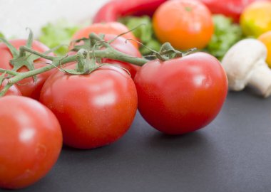 Domates masanın üzerinde. Kırmızı domates eski masaya yalan. Diyet yiyecek. Tablo arka planda sebze domates.