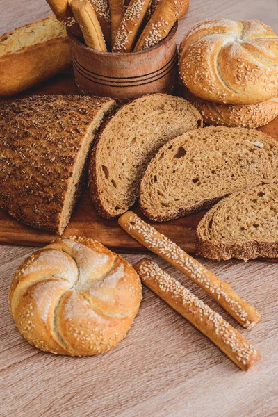 crisp bread with buns. French baguettes. Fresh crispbread. Bread background. Different breed  on wooden background.