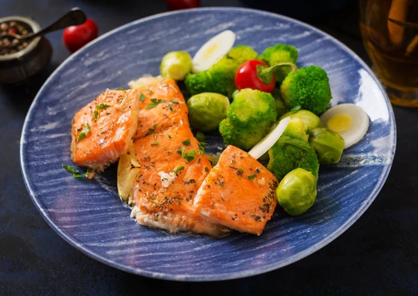 Baked salmon with broccoli in blue plate — Stock Photo, Image