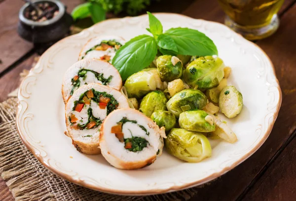 Chicken rolls with greens on blue plate — Stock Image Chicken rolls with greens on blue plate Royalty Free Stock Photos