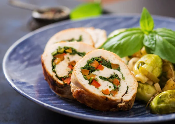 Chicken rolls with greens on blue plate — Stock Image Chicken rolls with greens on blue plate Stock Image
