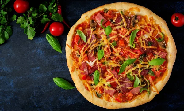 Pizza with salami on dark background — Stock Photo, Image
