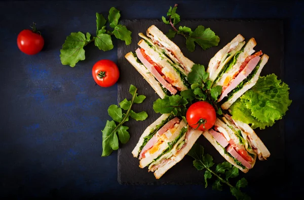 Club sandwiches on dark background. — Stock Photo, Image