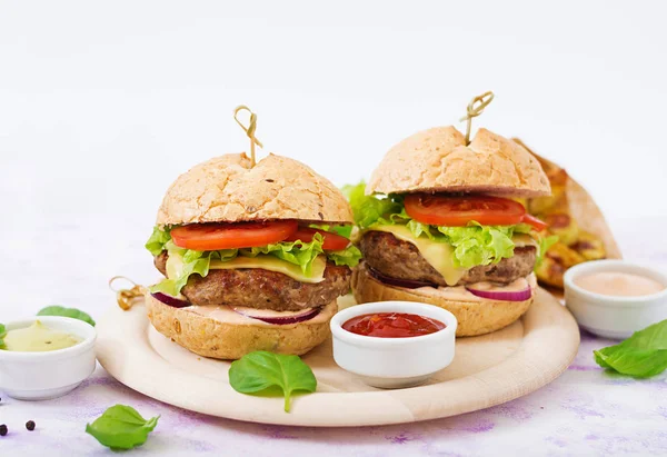 Beef burgers with sauces — Stock Photo, Image