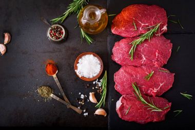 Raw beef steaks with spices clipart
