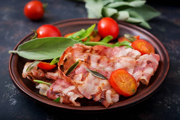 Fried bacon and tomatoes in plate — Stock Photo, Image