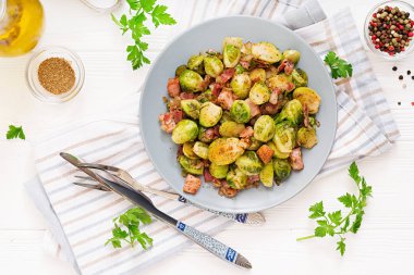 roasted brussels sprouts with bacon on plate  clipart