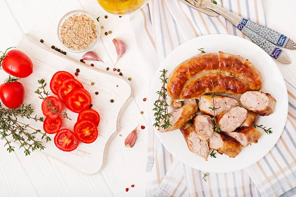 Baked Homemade Sausage White Plate Tomatoes Wooden Cutting Board — Stock Photo, Image